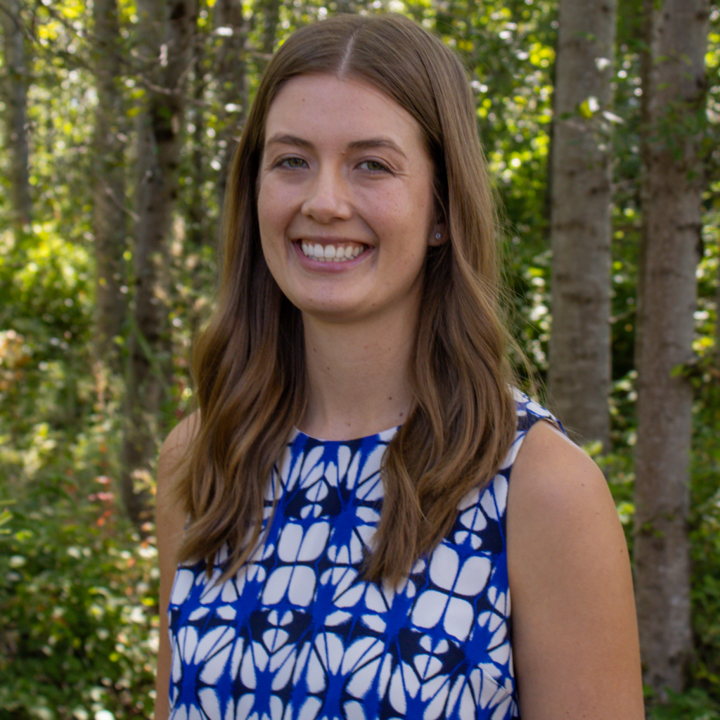 Headshot of Dr. Elizabeth with nature as the backdrop